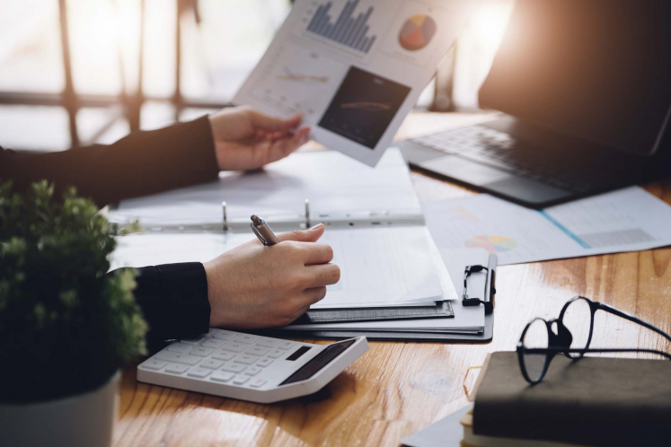 Employee analyzing information and taking notes