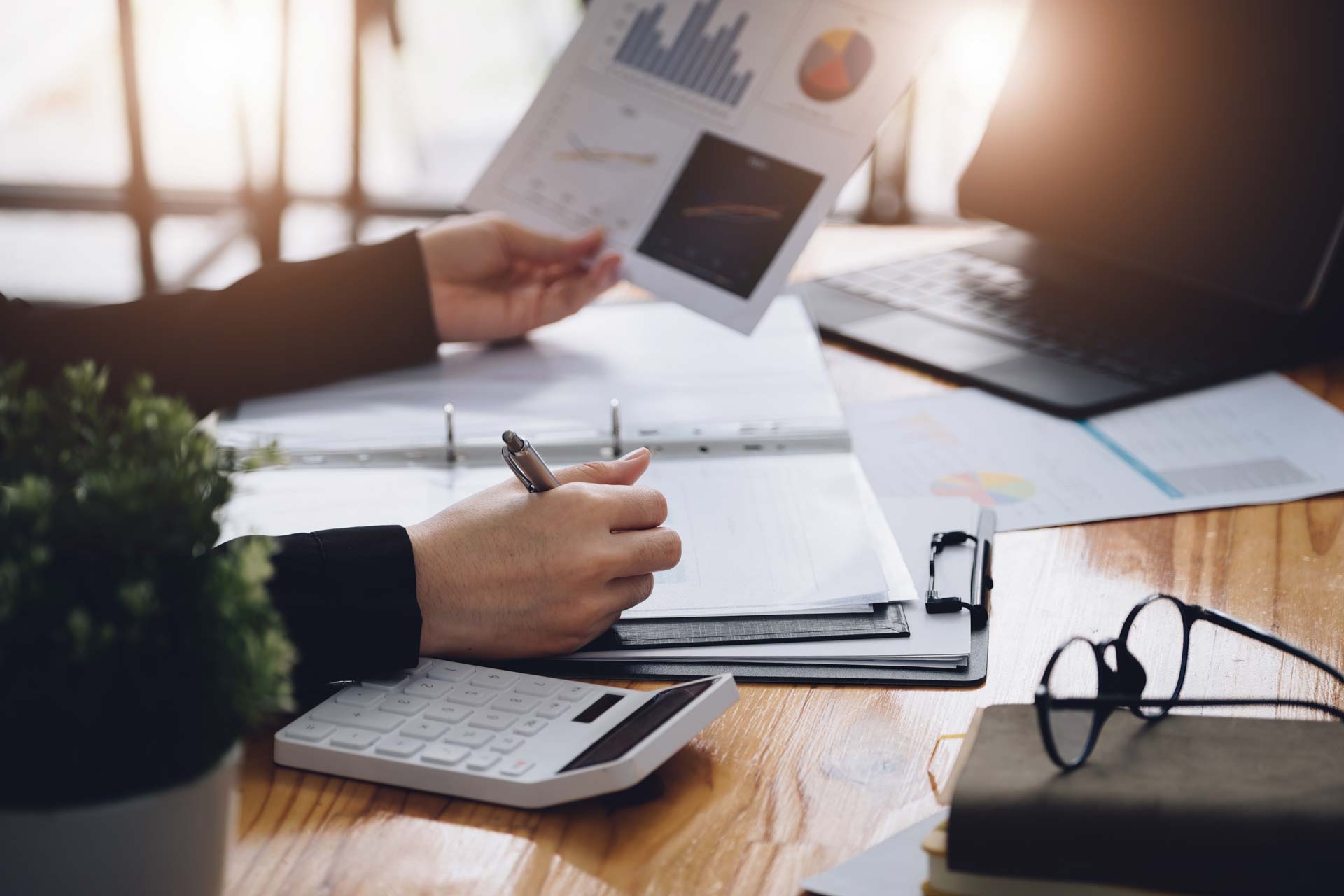 Employee analyzing information and taking notes