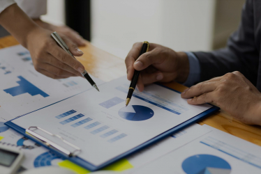 Employees analyzing data on papers